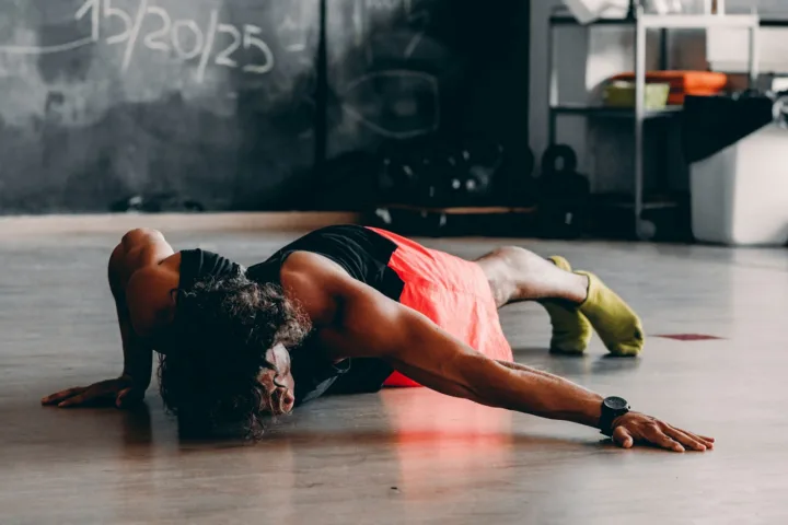 Person doing a push-up on the floor at home