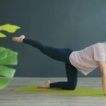 Woman doing a bird-dog exercise on a mat at home